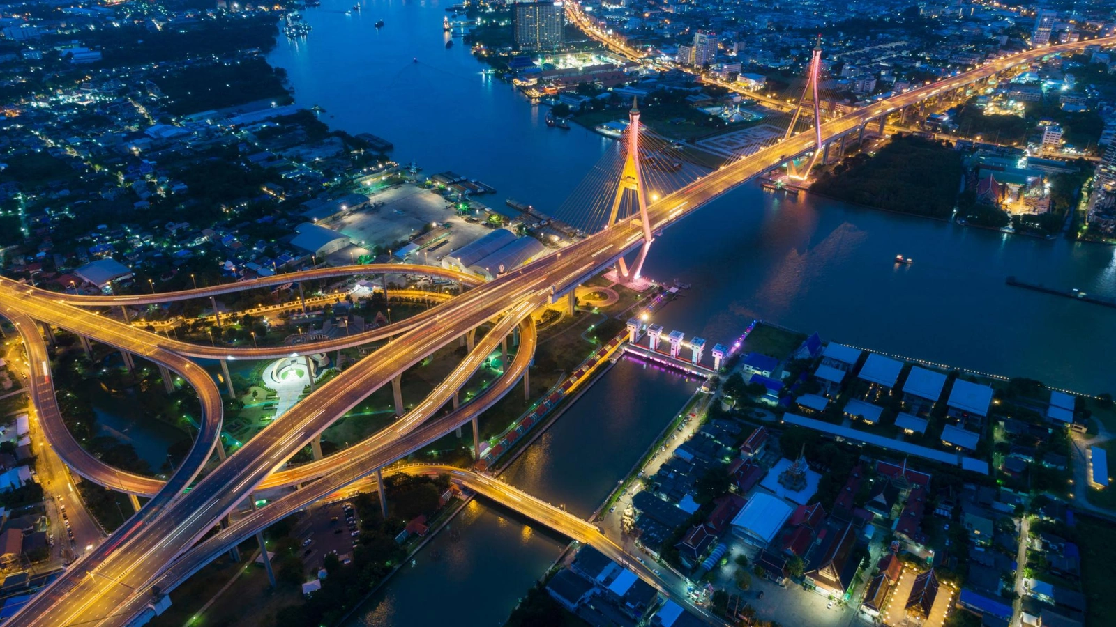 Aerial night view of illuminated bridges over a river