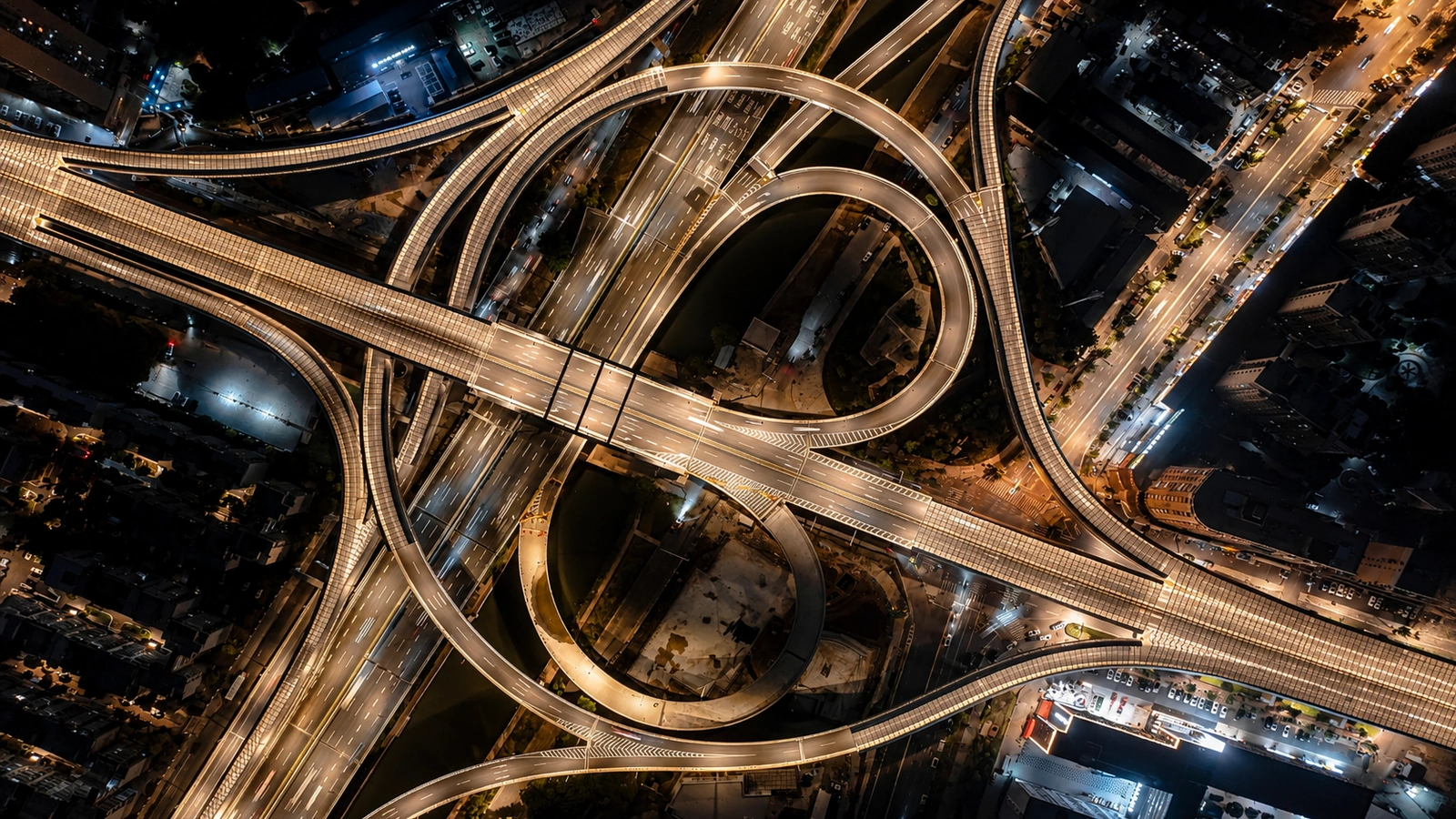 Aerial night view of illuminated highway interchanges