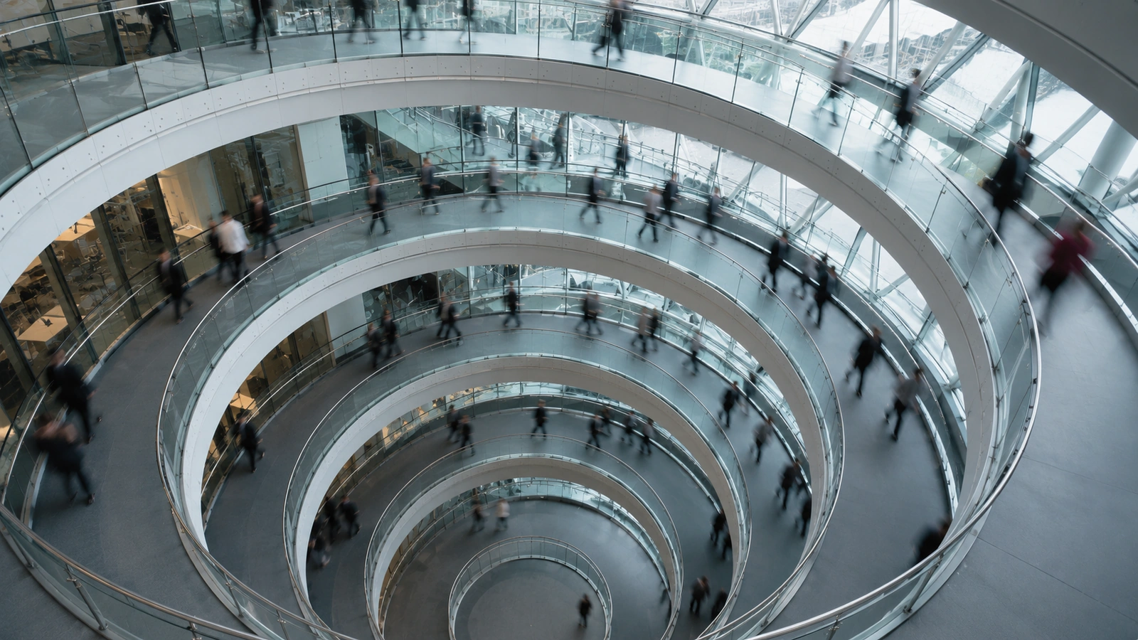 People moving through a circular glass atrium